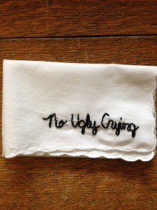white handkerchief with words 'no ugly crying' embroidered in black cotton 