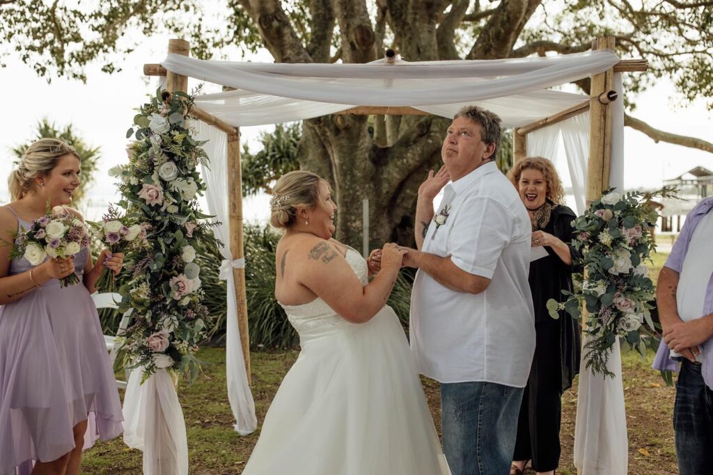 Groom being funny and bride and guests laughing aloud