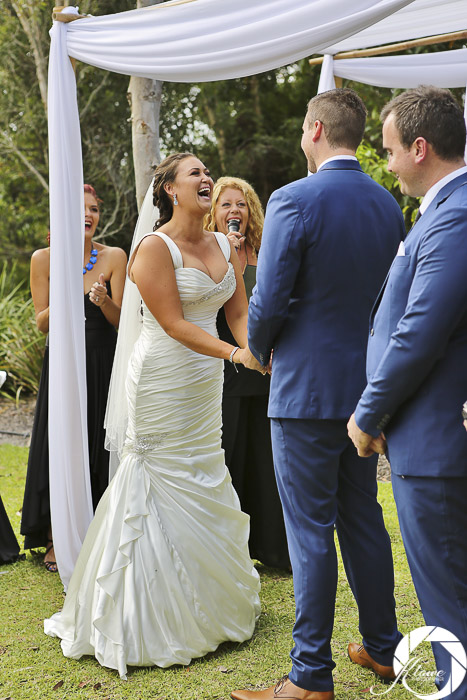 Bride and groom laughing as Lynette Maguire celebrant speaks bride belly laughing