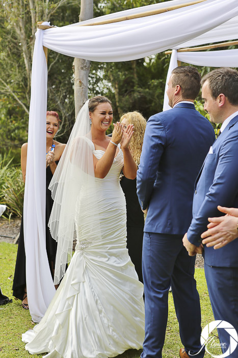 Bride and groom laughing as Lynette Maguire celebrant speaks bride clapping