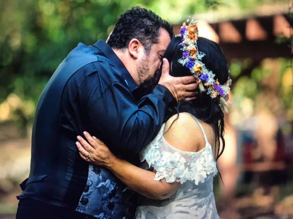 Groom kissing bride with floral crown