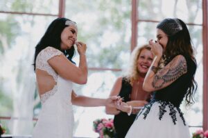 Two brides laughing and being married by Lynette