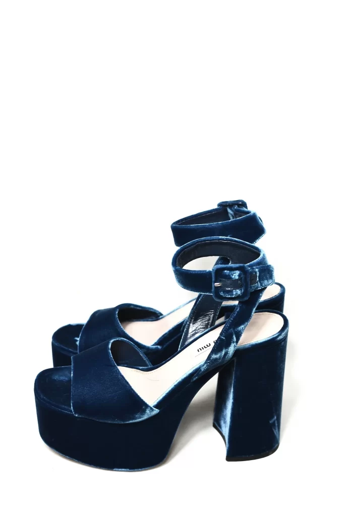Dark blue velvet shoes with high heels and ankle straps